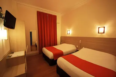 Un ou plusieurs lits dans un hébergement de l'établissement Hôtel De La Cathédrale