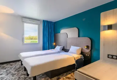 Un ou plusieurs lits dans un hébergement de l'établissement B&B HOTEL Compiègne Thourotte