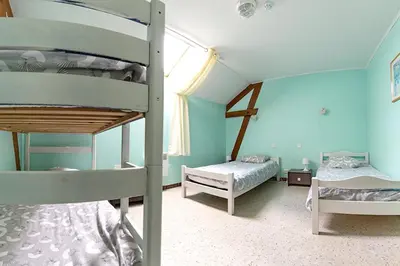 Un ou plusieurs lits dans un hébergement de l'établissement Maison accueillante près de Monthenault, parfaite pour groupes