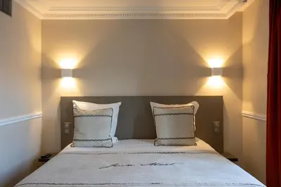 Un ou plusieurs lits dans un hébergement de l'établissement Hotel Jean Moët