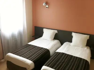 Un ou plusieurs lits dans un hébergement de l'établissement Fasthôtel Le Râle Des Genêts - Un hôtel FH Collection