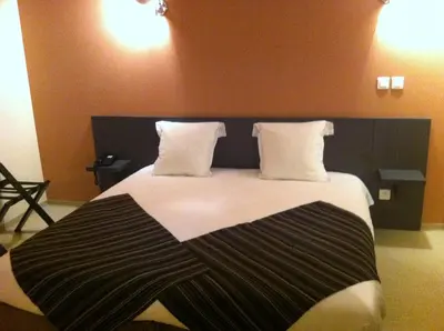 Un ou plusieurs lits dans un hébergement de l'établissement Fasthôtel Le Râle Des Genêts - Un hôtel FH Collection