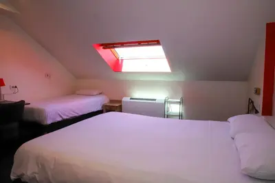 Un ou plusieurs lits dans un hébergement de l'établissement Hotel Aux Sacres Reims, Centre Historique