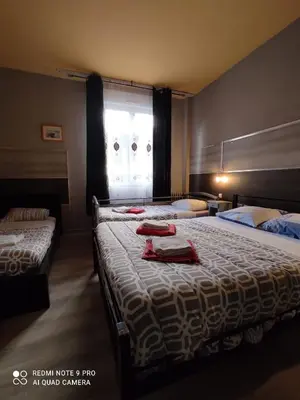 Un ou plusieurs lits dans un hébergement de l'établissement Hotel Le Bon Moine