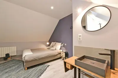 Un ou plusieurs lits dans un hébergement de l'établissement Chambres d'hotes Les Nuits Pastel