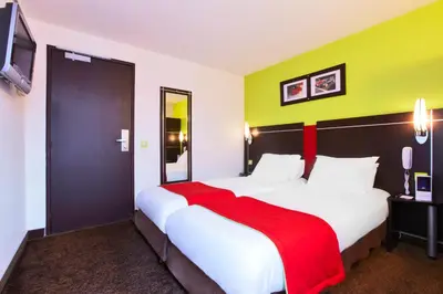 Un ou plusieurs lits dans un hébergement de l'établissement Enzo Hotels Reims Tinqueux
