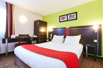 Un ou plusieurs lits dans un hébergement de l'établissement Enzo Hotels Reims Tinqueux