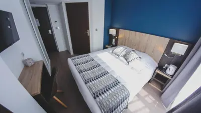 Un ou plusieurs lits dans un hébergement de l'établissement Hôtel du Tramway