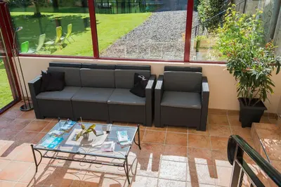 Coin salon dans l'établissement Au Jardin Fleuri