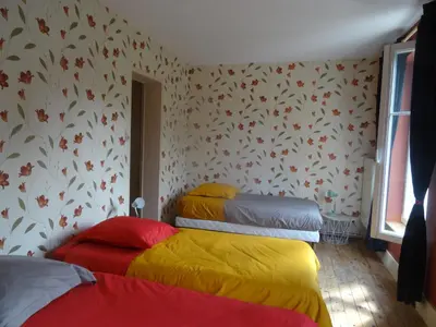 Un ou plusieurs lits dans un hébergement de l'établissement Cour et Jardin