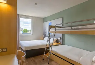 Un ou plusieurs lits dans un hébergement de l'établissement B&B HOTEL Meaux