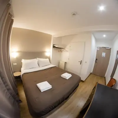 Un ou plusieurs lits dans un hébergement de l'établissement Hôtel des Arcades