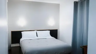 Un ou plusieurs lits dans un hébergement de l'établissement Hôtel des Arcades