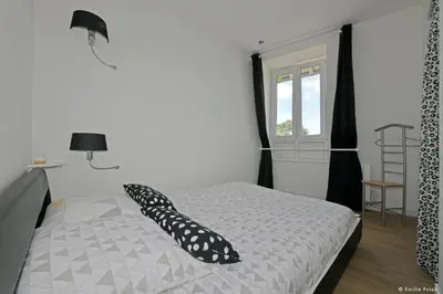 Un ou plusieurs lits dans un hébergement de l'établissement Comme à la Maison - DE LA TOUR