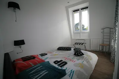 Un ou plusieurs lits dans un hébergement de l'établissement Comme à la Maison - DE LA TOUR