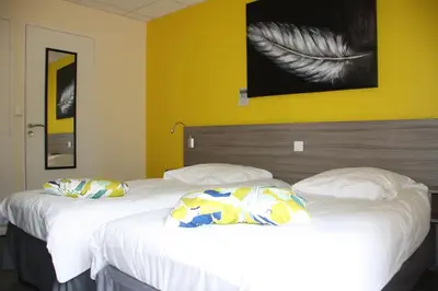 Un ou plusieurs lits dans un hébergement de l'établissement Hôtel L'Argonn' Auberge