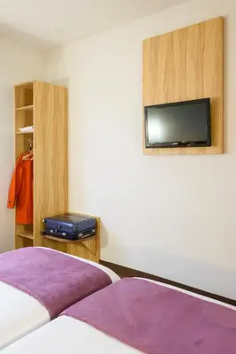 Un ou plusieurs lits dans un hébergement de l'établissement Brit Hotel Reims Croix Blandin