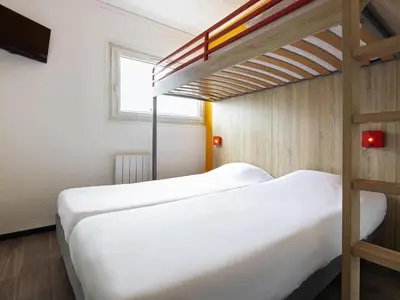 Un ou plusieurs lits dans un hébergement de l'établissement Hôtel F1 Reims Tinqueux