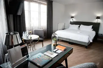 Un ou plusieurs lits dans un hébergement de l'établissement Armes de Champagne Hôtel & Spa