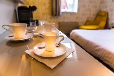Un ou plusieurs lits dans un hébergement de l'établissement Cit'Hotel - Hotel Le Cèdre