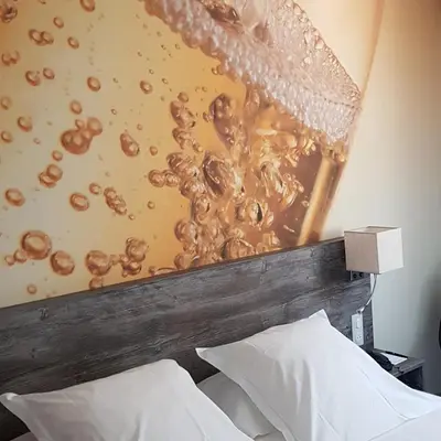 Un ou plusieurs lits dans un hébergement de l'établissement Hotel de Champagne