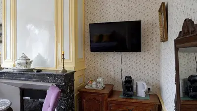 Télévision ou salle de divertissement dans l'établissement Au Chapitre