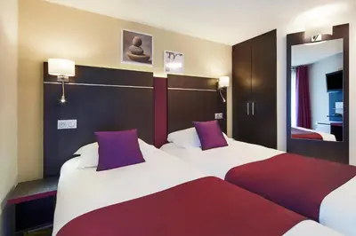 Un ou plusieurs lits dans un hébergement de l'établissement Kyriad Hotel Meaux