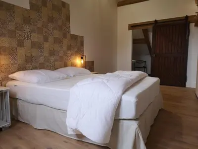 Un ou plusieurs lits dans un hébergement de l'établissement Cottage AU TERMINUS 2 climatisé
