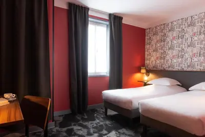 Un ou plusieurs lits dans un hébergement de l'établissement Hôtel Bristol Reims