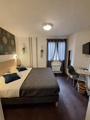 Un ou plusieurs lits dans un hébergement de l'établissement Hotel Au Bon Sejour