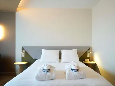 Un ou plusieurs lits dans un hébergement de l'établissement Novotel Reims Tinqueux