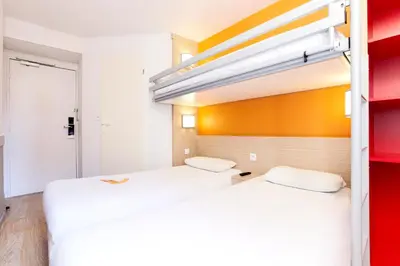 Un ou plusieurs lits dans un hébergement de l'établissement Premiere Classe Reims Sud - Bezannes
