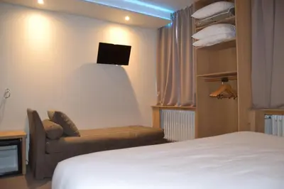 Un ou plusieurs lits dans un hébergement de l'établissement Cit'Hotel De Harlay