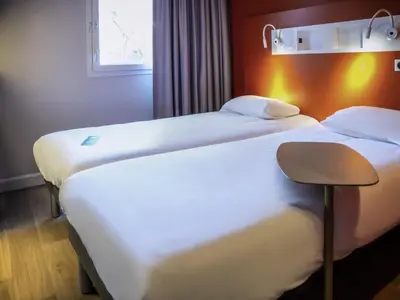Un ou plusieurs lits dans un hébergement de l'établissement ibis budget Reims Parc Des Expositions