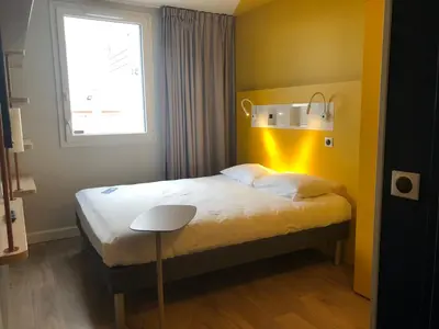 Un ou plusieurs lits dans un hébergement de l'établissement ibis budget Reims Parc Des Expositions