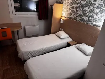 Un ou plusieurs lits dans un hébergement de l'établissement Hôtel Classe Eco Reims Tinqueux