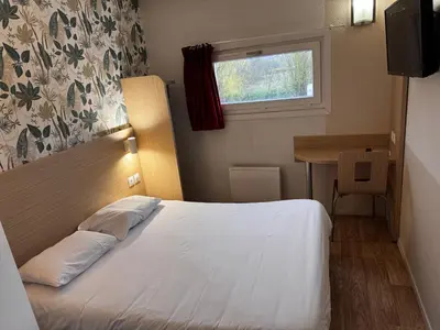 Un ou plusieurs lits dans un hébergement de l'établissement Hôtel Classe Eco Reims Tinqueux