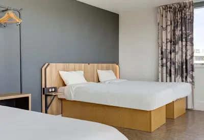 Un ou plusieurs lits dans un hébergement de l'établissement B&B HOTEL Reims Bezannes