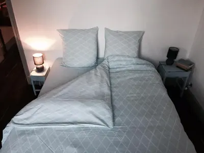 Un ou plusieurs lits dans un hébergement de l'établissement GrIsa'Home le gîte