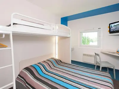Un ou plusieurs lits dans un hébergement de l'établissement ENZO HOTELS 1er PRIX CHARLEVILLE