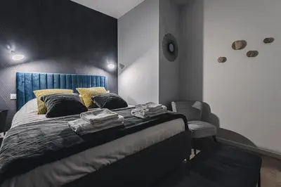 Un ou plusieurs lits dans un hébergement de l'établissement Art Déco Gare & Spa