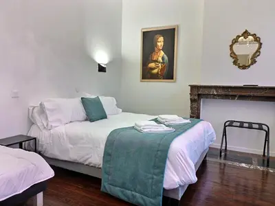 Un ou plusieurs lits dans un hébergement de l'établissement Les Appartements Fénelon