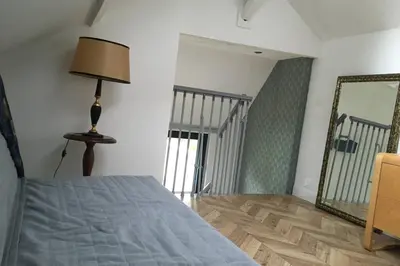 Un ou plusieurs lits dans un hébergement de l'établissement La petite Brainoise - Gîte avec salle jacuzzi 120 jets