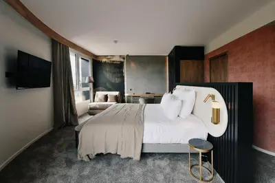 Un ou plusieurs lits dans un hébergement de l'établissement Golden Tulip Reims Bezannes