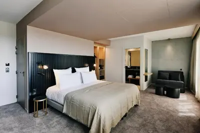Un ou plusieurs lits dans un hébergement de l'établissement Golden Tulip Reims Bezannes