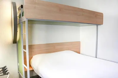 Un ou plusieurs lits dans un hébergement de l'établissement Hôtel Inn Design Laon