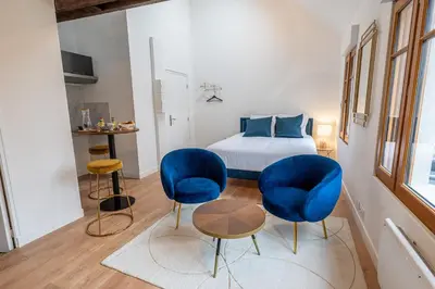 Un ou plusieurs lits dans un hébergement de l'établissement Le Magnifique Appart'Hotel Le Gatsby