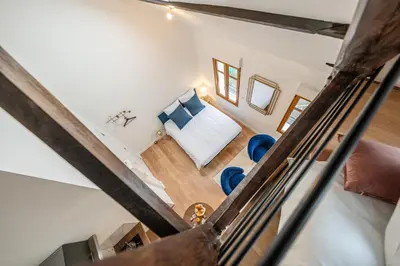 Un ou plusieurs lits dans un hébergement de l'établissement Le Magnifique Appart'Hotel Le Gatsby