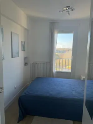 Un ou plusieurs lits dans un hébergement de l'établissement appartement neuf style architecte au calme