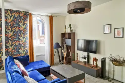 Télévision ou salle de divertissement dans l'établissement Les Appartements de la Nef d'Or